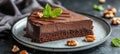 Slice of Chocolate Layer Cake Decorated with Chocolate Ganache, Pecans,and Fresh Mint Royalty Free Stock Photo