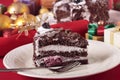 Slice of Christmas black forest gateau chocolate cake with plate and fork Royalty Free Stock Photo