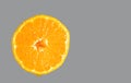 A slice of a circle of juicy orange with a drop of juice, on a gray trendy 2021 background banner copy space