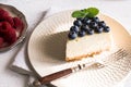 Slice Of Classical New York Cheesecake with blueberries On White Plate. Closeup View. Home bakery concept Royalty Free Stock Photo