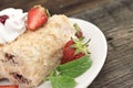 Slice of cream puff cake with strawberry on wooden table. Select Royalty Free Stock Photo