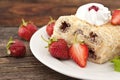 Slice of cream puff cake with strawberry on wooden table. Select Royalty Free Stock Photo