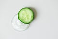 Slice of cucumber on sample pure cosmetic gel smudge on white background and copy space. Making natural organic cosmetics