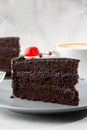 A slice of delicious chocolate cake with cherry on top on marble background. Piece of Cake on a Plate. Sweet food. Sweet dessert. Royalty Free Stock Photo