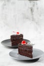 A slice of delicious chocolate cake with cherry on top on marble background. Piece of Cake on a Plate. Sweet food. Sweet Royalty Free Stock Photo