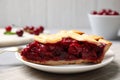 Slice of delicious fresh cherry pie on table, closeup Royalty Free Stock Photo