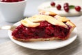Slice of delicious fresh cherry pie on table, closeup Royalty Free Stock Photo