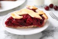 Slice of delicious fresh cherry pie on marble table, closeup Royalty Free Stock Photo