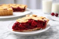 Slice of delicious fresh cherry pie on white marble table, closeup Royalty Free Stock Photo