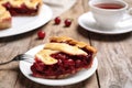 Slice of delicious fresh cherry pie on wooden table, closeup Royalty Free Stock Photo