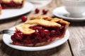 Slice of delicious fresh cherry pie on wooden table, closeup Royalty Free Stock Photo