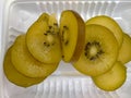 The slice delicious of golden kiwi fruit is occurring on the white tray enriched vitamin and nutrition