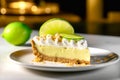 Slice of delicious key lime pie with whipped cream and garnished with lime on white plate. Traditional American dessert