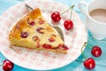 Slice of delicious pie with cherries and cream filling on plate Royalty Free Stock Photo