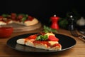 Slice of delicious pita pizza on wooden table