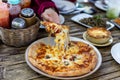 Slice of delicious pizza On a plate on wooden table Royalty Free Stock Photo