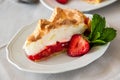 Slice of delicious strawberry tart with meringue on wooden background. Summer food Royalty Free Stock Photo