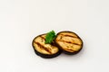 Slice of eggplant roasted on a grill with stripes from a grill on a white background Royalty Free Stock Photo