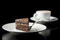 Slice of fresh chocolate cake served with coffee