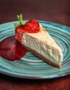 Slice of fresh delicious cheesecake with strawberry and leaf of mint Royalty Free Stock Photo