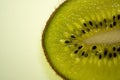 Slice of fresh juicy kiwi fruit close up, macro background. Royalty Free Stock Photo