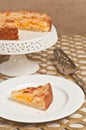 slice of freshly baked, plum custard tart on a round, white plate Royalty Free Stock Photo