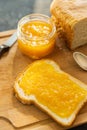 Slice of freshly baked rural bread with homemade citrus jam. Selective focus