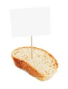 Slice of a full corn white bread with blank cardboard information tag