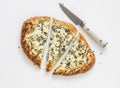 Slice of gorgonzola, pear, honey, sesame pizza on a light background, top view