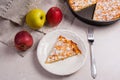 Slice of homemade apple pie with fork and fresh apples on light Royalty Free Stock Photo