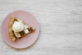 Slice of homemade apple pie with ice cream on pink plate on white wooden surface, top view. Flat lay, overhead, from above. Copy Royalty Free Stock Photo