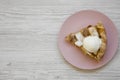 Slice of homemade apple pie with ice cream on pink plate on white wooden table, top view. Flat lay, overhead, from above. Copy Royalty Free Stock Photo