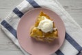 Slice of homemade apple pie with vanilla ice cream on a pink plate, top view. From above, overhead, flat lay Royalty Free Stock Photo