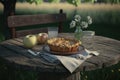 A slice of homemade apple pie on vintage wooden table in apple orchard