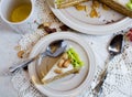 Slice of homemade carrot cake with cream cheese frosting on white plate. Vintage doily on table Royalty Free Stock Photo