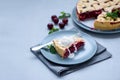 Slice of homemade cherry lattice cake on gray wooden background. Traditional american food