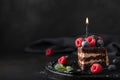 slice of homemade chocolate cake with fresh berries and birthday candle Royalty Free Stock Photo