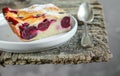 A slice of homemade clafoutis cherry pie - traditional french dessert in a gray plate Royalty Free Stock Photo