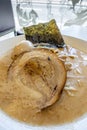 Slice of Japanese Char Siu roast pork on top of Ramen Noodle broth