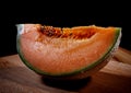 Slice of juicy melon on a wooden board Royalty Free Stock Photo