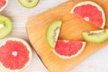 Slice kiwi, grapefruit pattern on wooden background. copy space Royalty Free Stock Photo