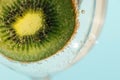 Slice of kiwi submerged in surrounded with bubbles. Royalty Free Stock Photo