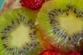 Kiwi and a variety of fresh fruits in sweet gelatin. Berries close-up in soft focus. Delicious dessert. Background of fruit. Food. Royalty Free Stock Photo