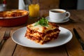 Slice of lasagna arranged neatly on the kitchen table bird