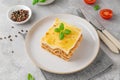 Slice of Lasagna bolognese with meat sauce and bechamel with melted cheese on top and fresh basil. Italian cusine. Copy space Royalty Free Stock Photo