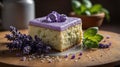 Lavender Infused Cake Square Topped with Purple Icing and Lavender Flowers Close-Up on Wooden Tray. Royalty Free Stock Photo