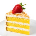 A slice of layered lemon cake topped with a fresh strawberry and coconut flakes Royalty Free Stock Photo