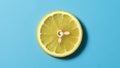 A slice of lemon Citrus limon is centered on a blue background Royalty Free Stock Photo