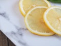 Slice lemon fruit on marble cutting board. Royalty Free Stock Photo