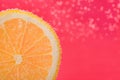 Slice of lemon in sparkling water on pink background, closeup with space for text. Citrus soda Royalty Free Stock Photo